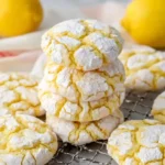 Stacked {{ $('Fetch Recipe Data').first().json["Main Keyword"] }} with powdered sugar on a wire cooling rack.