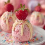 Pink {{ $('Fetch Recipe Data').first().json["Main Keyword"] }} with white chocolate, sprinkles & a strawberry.
